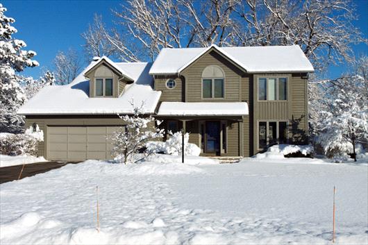 House and lawn covered in snow
